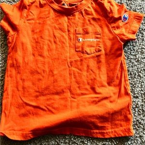Orang and black champion shirt size is 4T